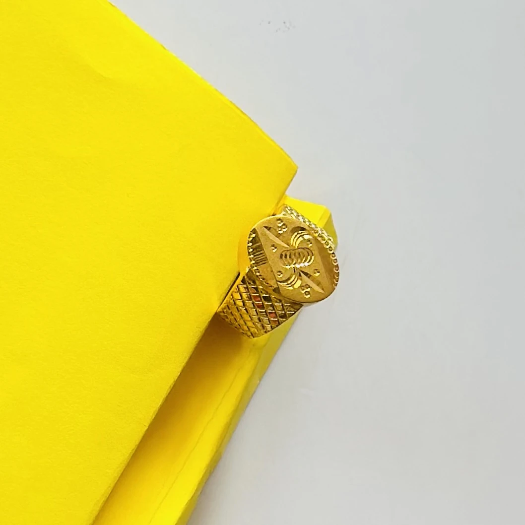 22kt yellow gold men's ring with a matte finish and machine-cut designs.