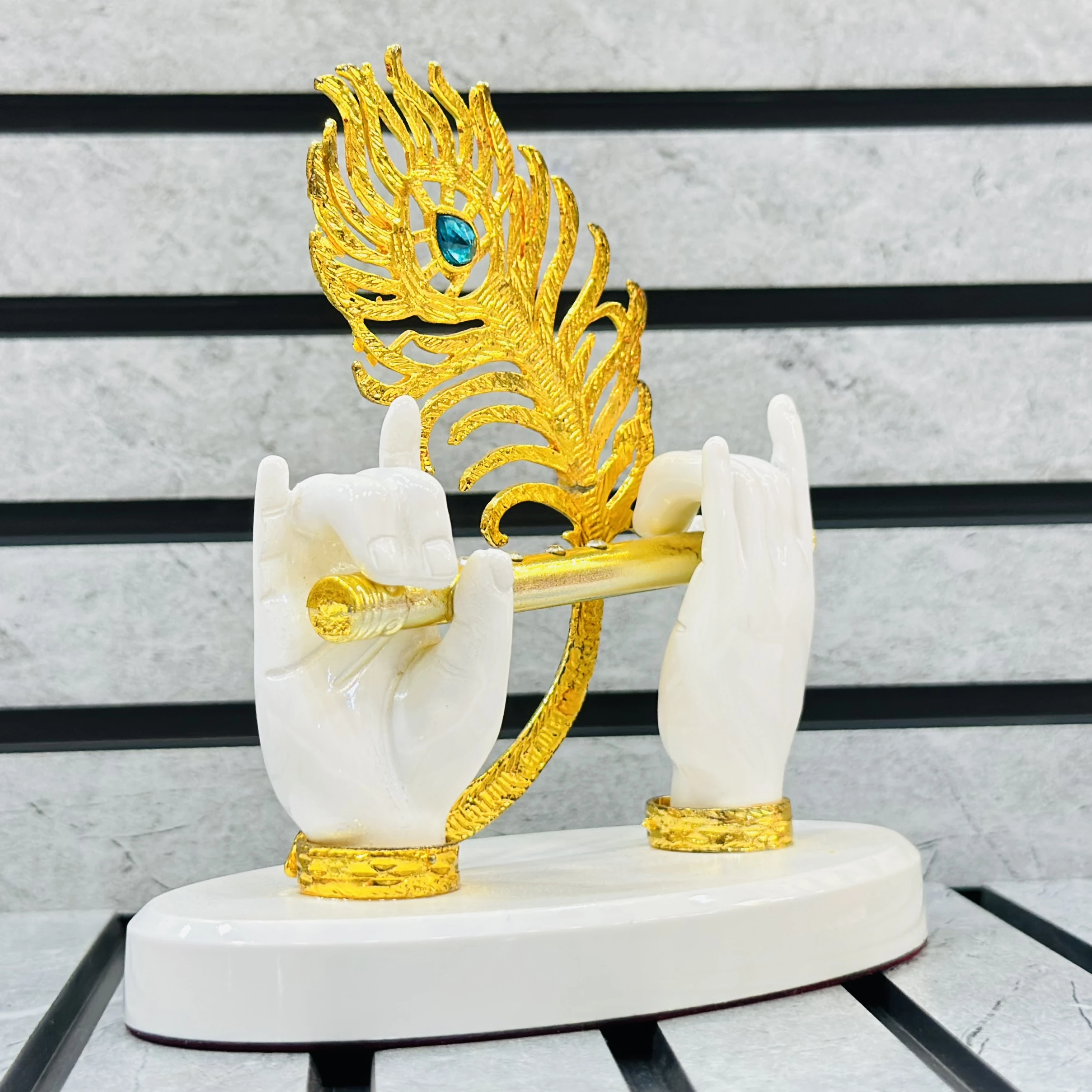 Gold gold-plated Lord Krishna hands with flute and peacock feather figurine.