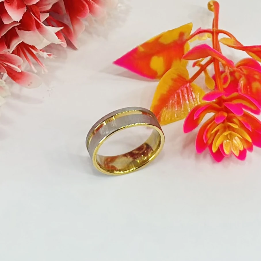 gold and silver-toned stainless steel dual-edge wedding band with a brushed finish
