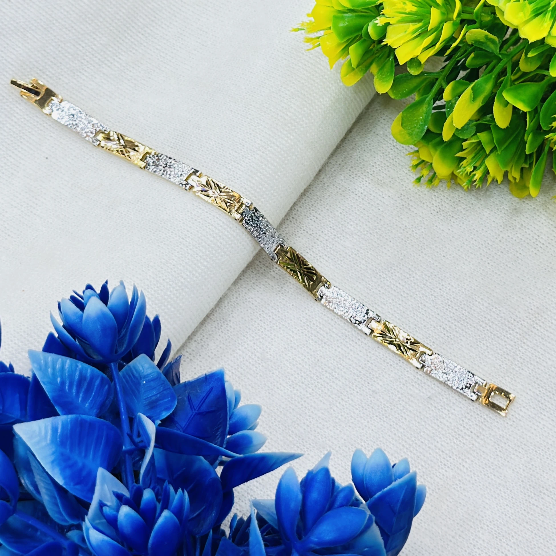 Gold plated men's bracelet featuring a textured, two-tone design.