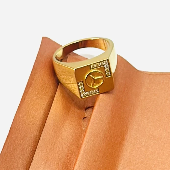 Gold plated men's finger ring with a Mercedes-Benz logo and diamond accents