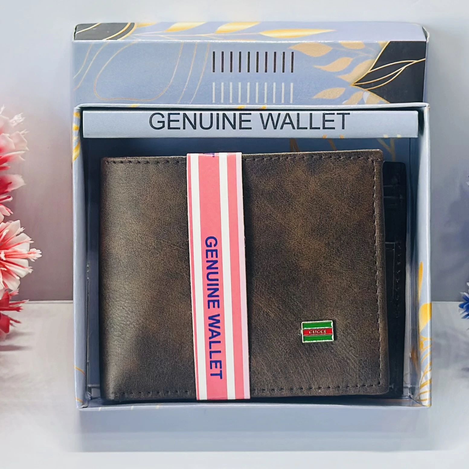 brown bifold wallet with "Genuine Wallet" text and a small "Queen" logo.
