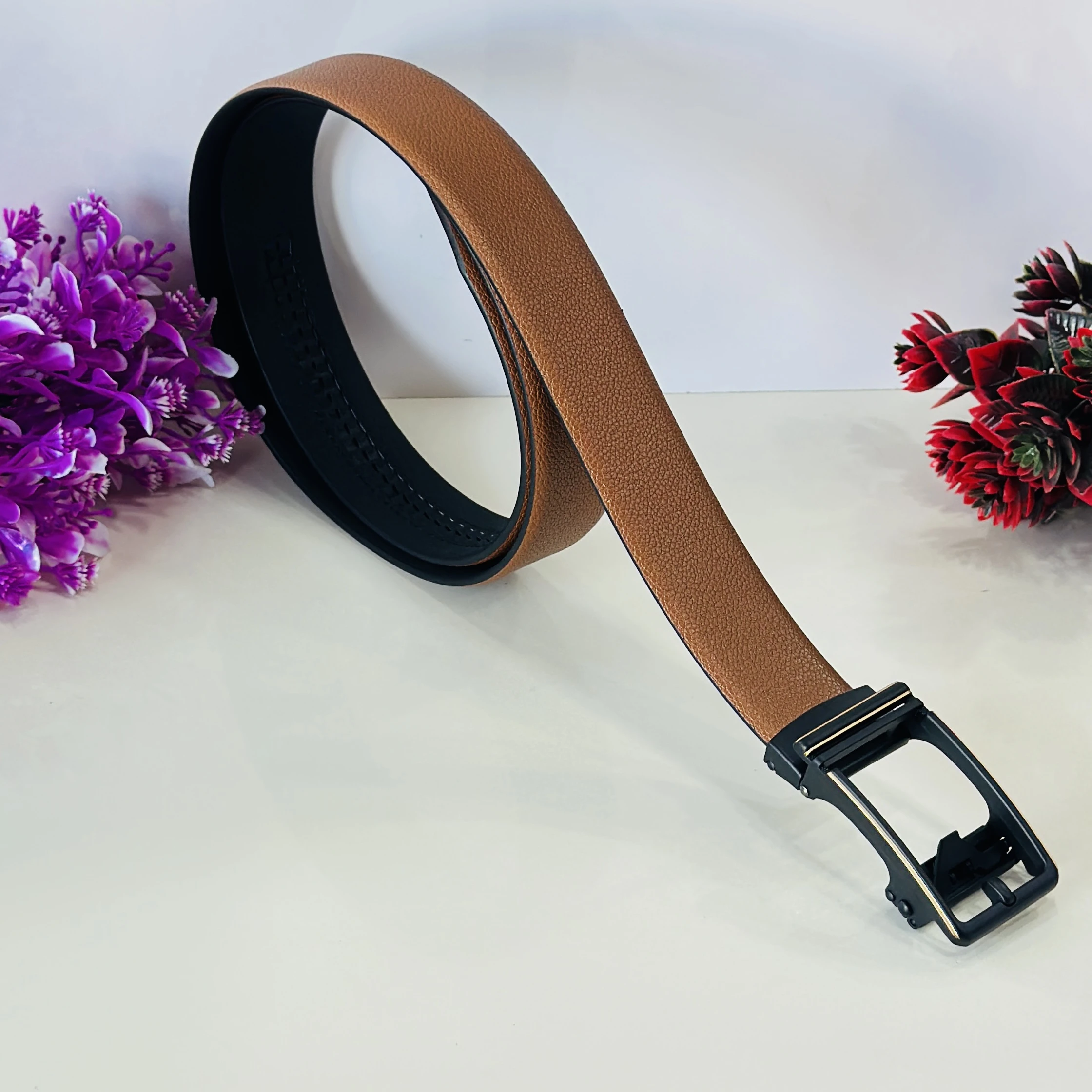 Tan and black reversible formal belt with an auto-lock buckle.