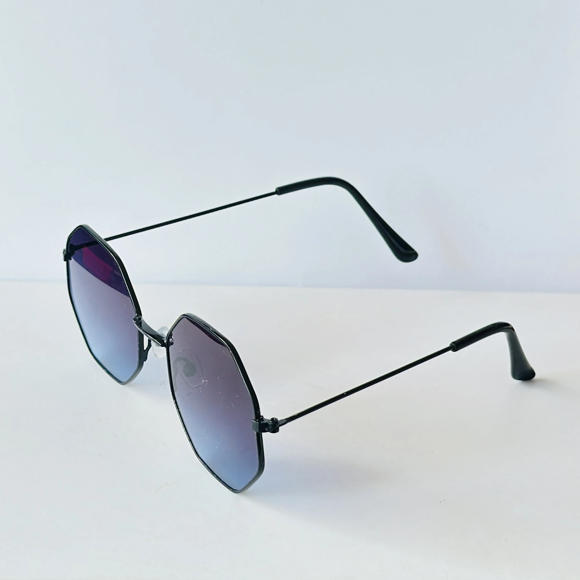 sunglasses appear to be similar to Vincent Chase Octagon Metal Frame Sunglasses