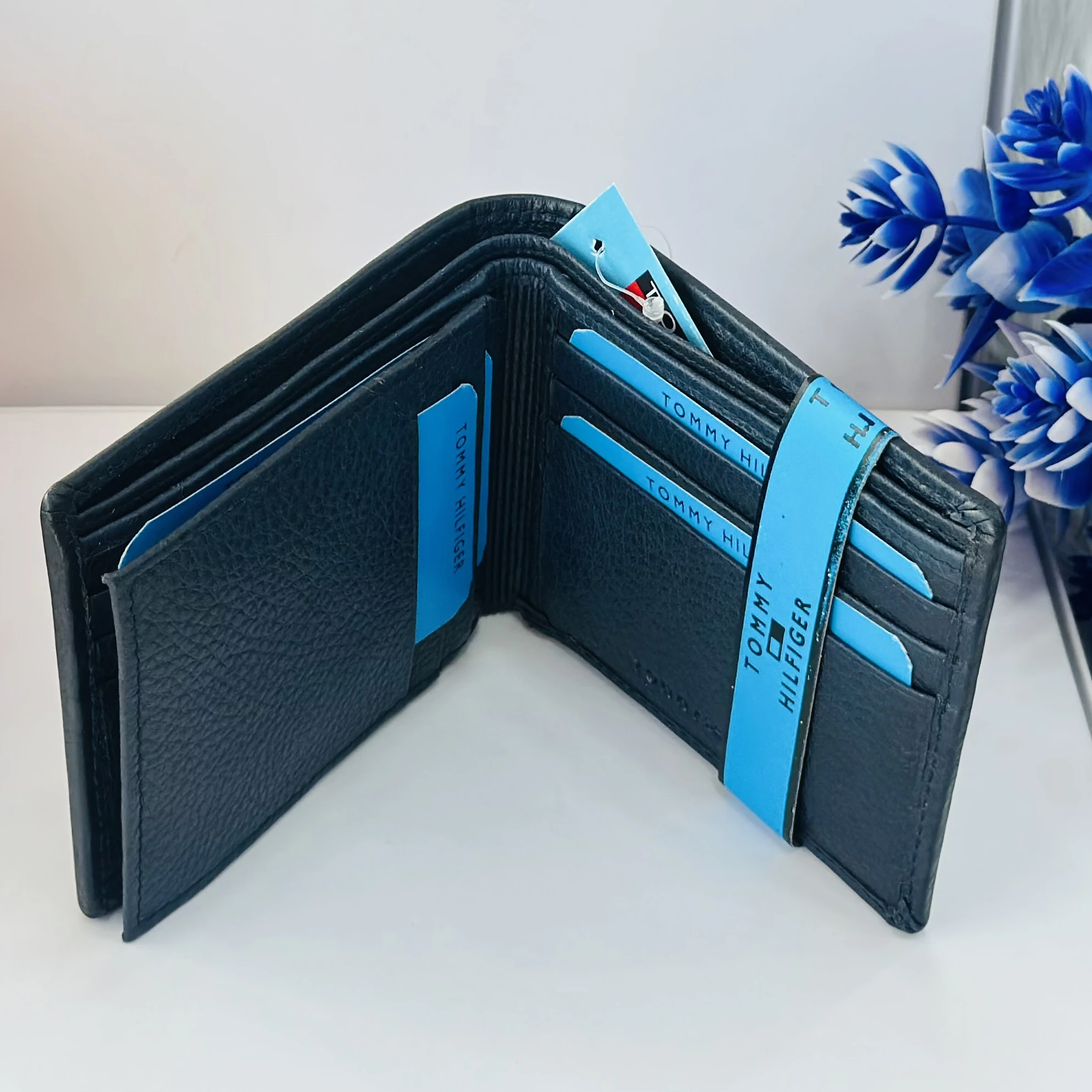 Blue Tommy Hilfiger men's genuine leather bi-fold wallet.