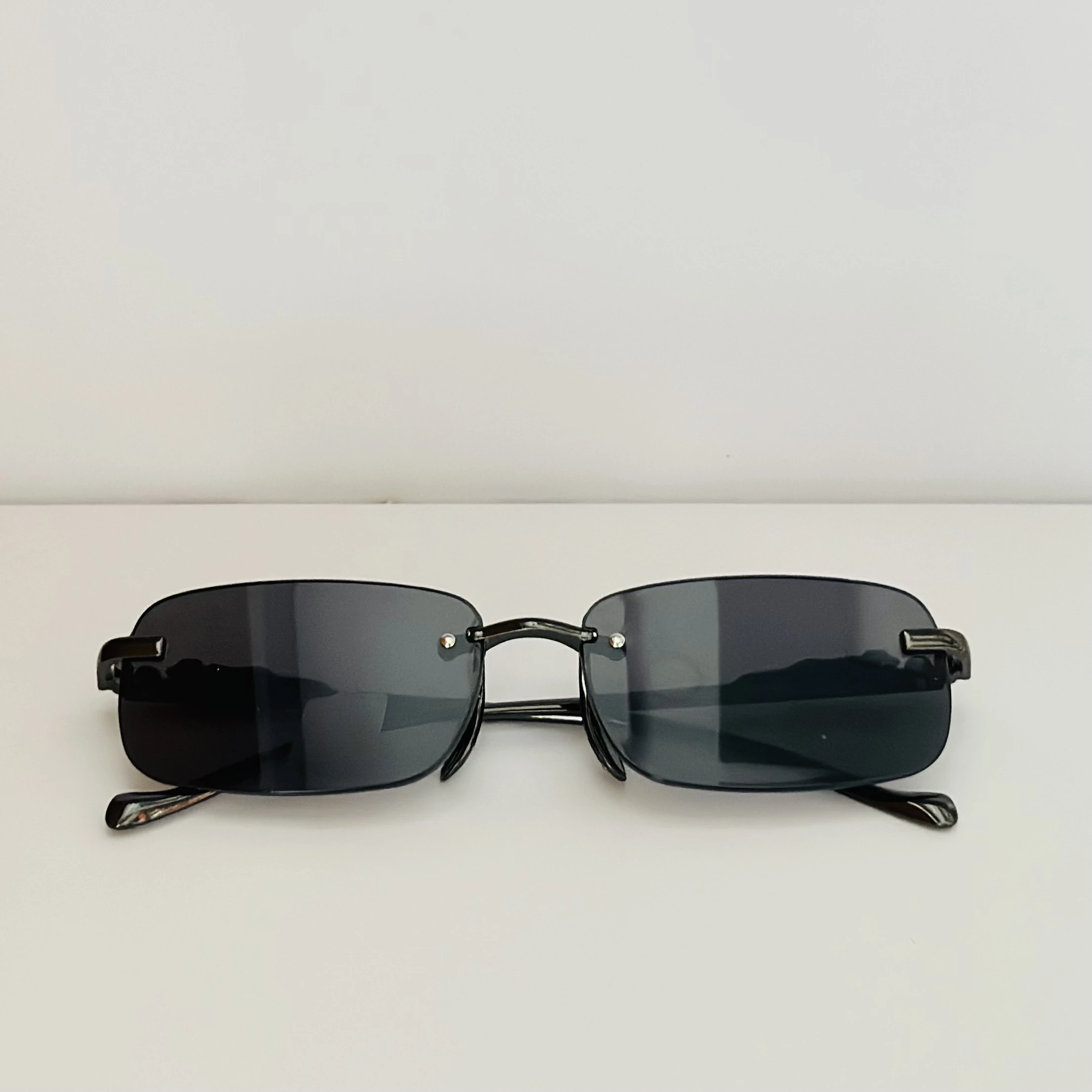 Creature Mc Stan rimless unisex rectangular sunglasses in black.