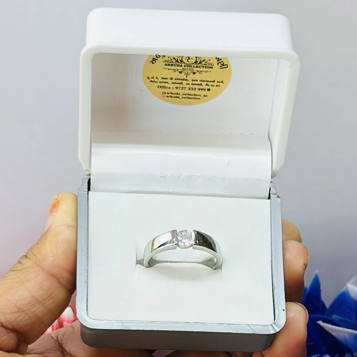 silver solitaire ring with a modern tension-style