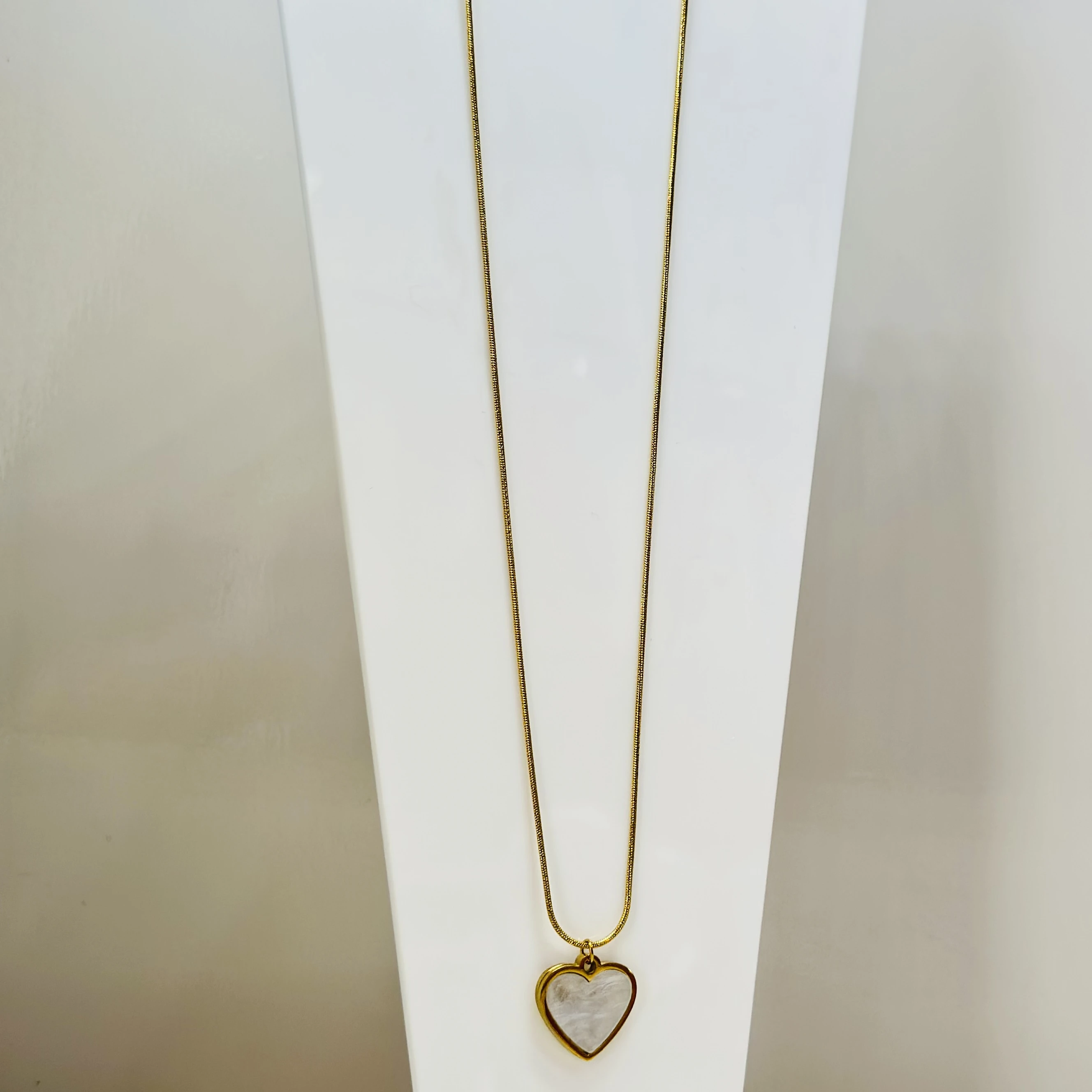 gold-plated snake chain  a white heart pendant.
