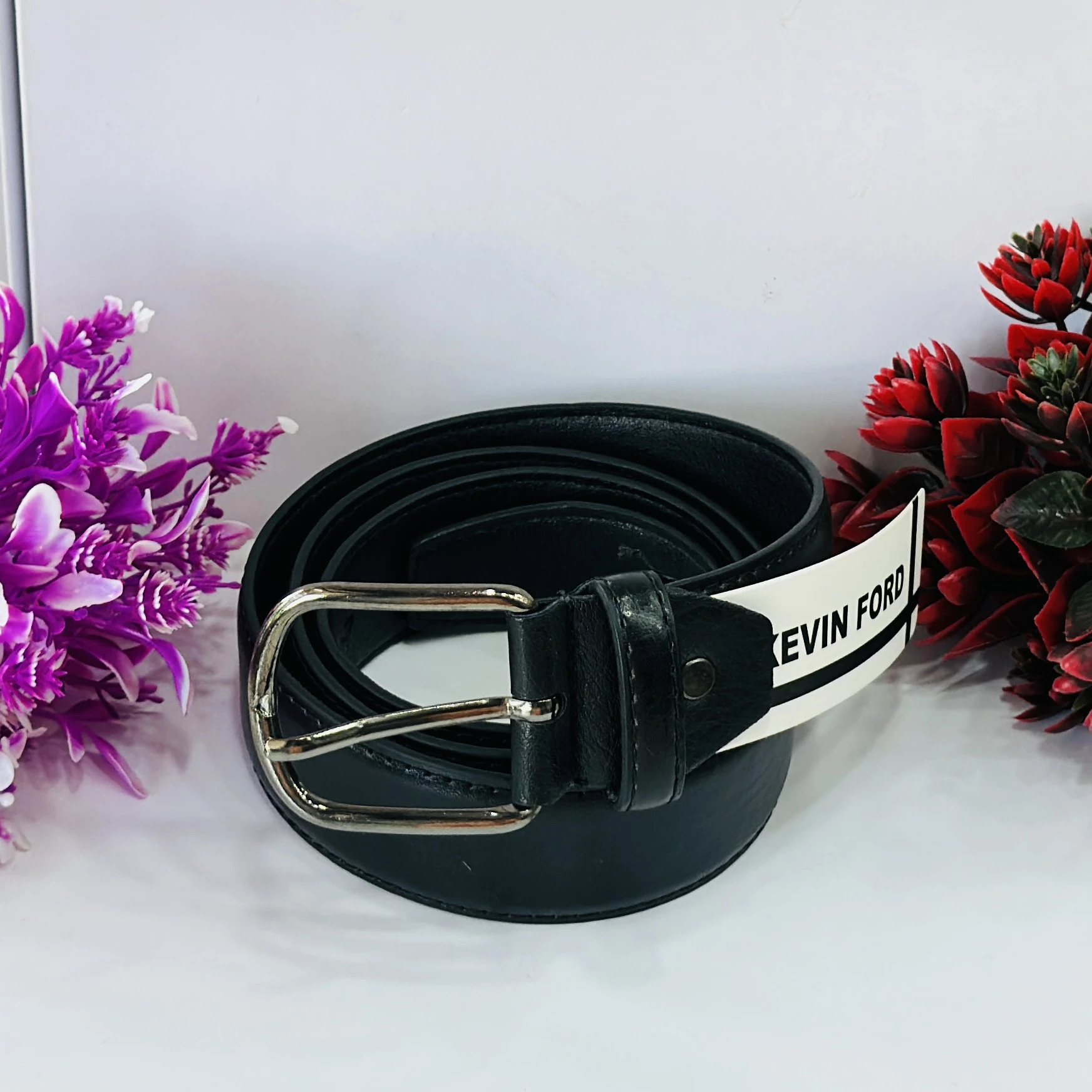 Black leather belt with a metal buckle.
