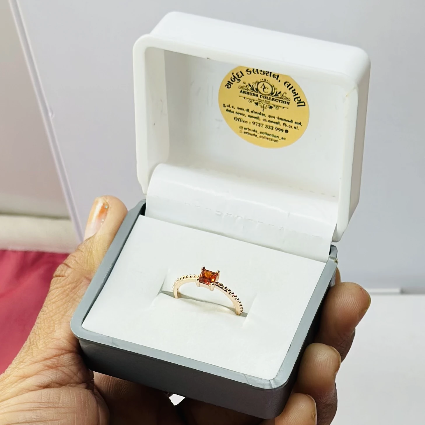 sterling silver ring with a rectangular orange gemstone, possibly hessonite garnet or citrine.