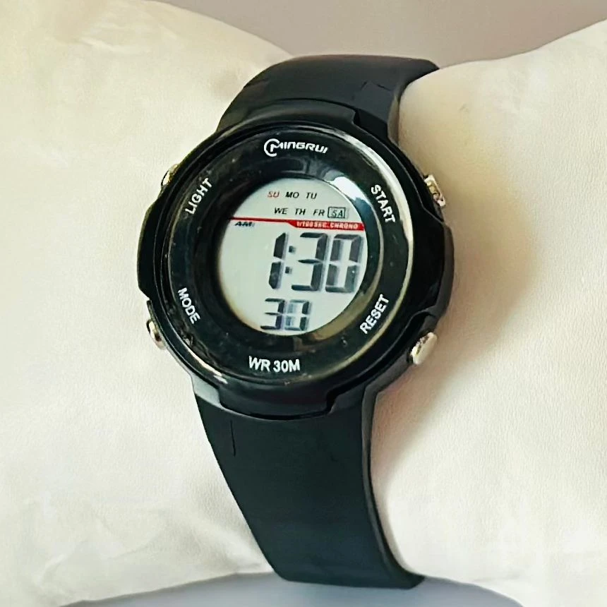 black Mingrui digital sports watch with a plastic or rubber strap.