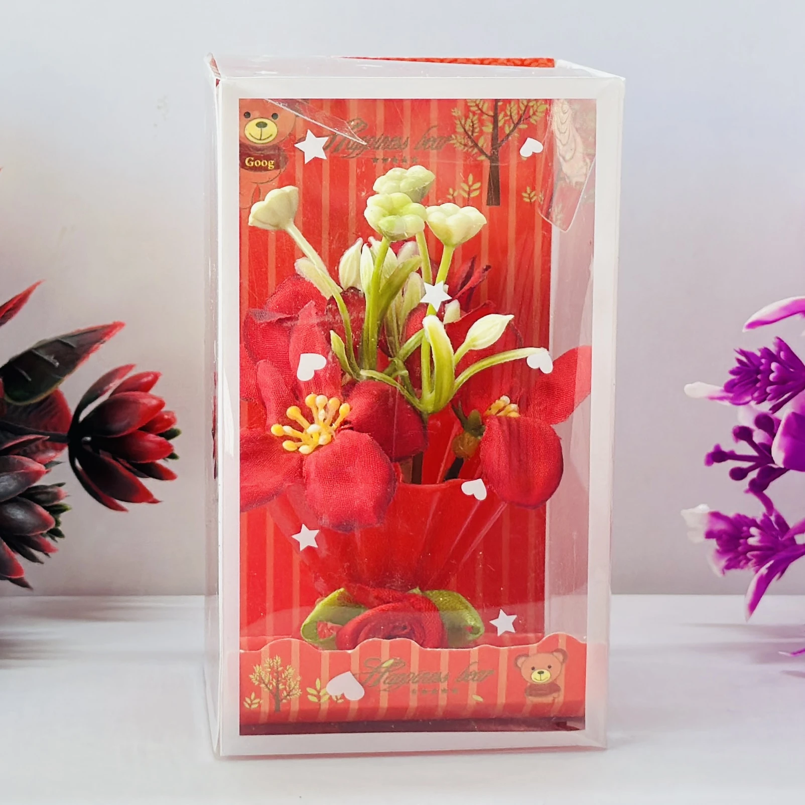 Red Rose flower arrangement in a pot, packaged in a clear plastic gift box.