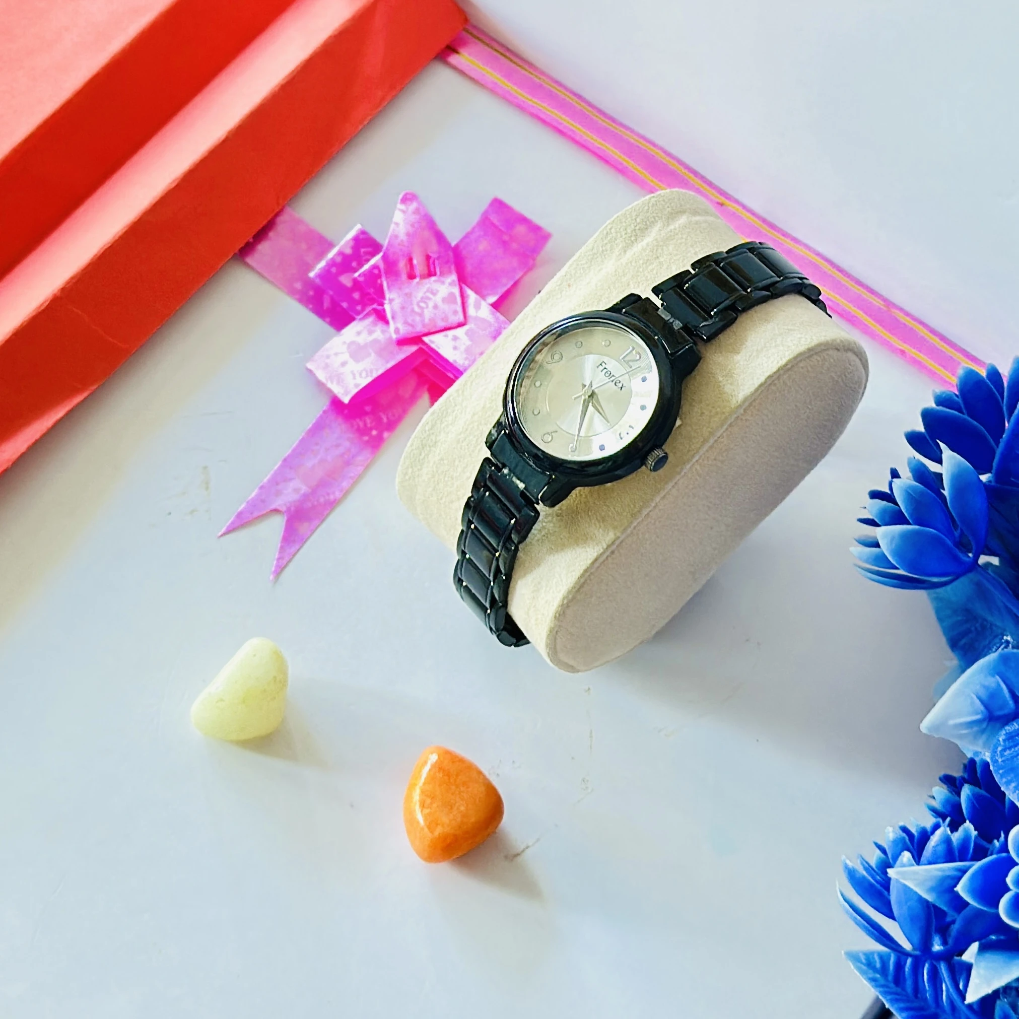 appears to be a black analog wristwatch for women