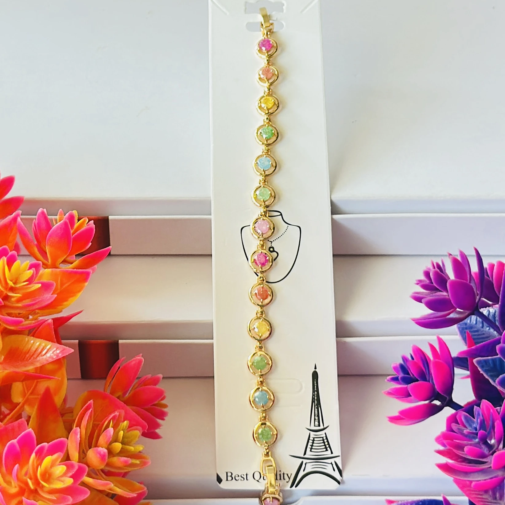 Gold plated chain bracelet with multicolor oval-shaped stones.