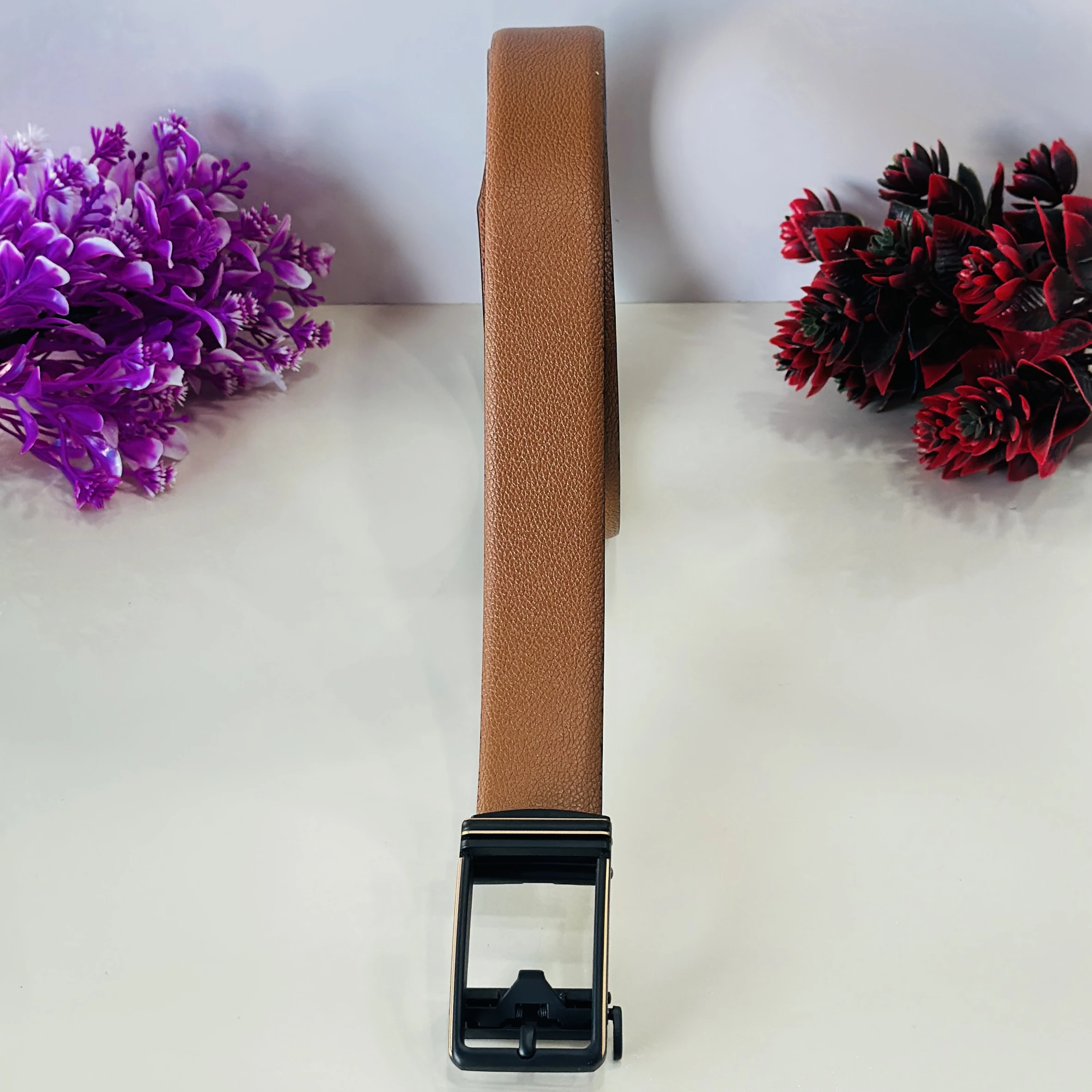 Tan and black reversible formal belt with an auto-lock buckle.