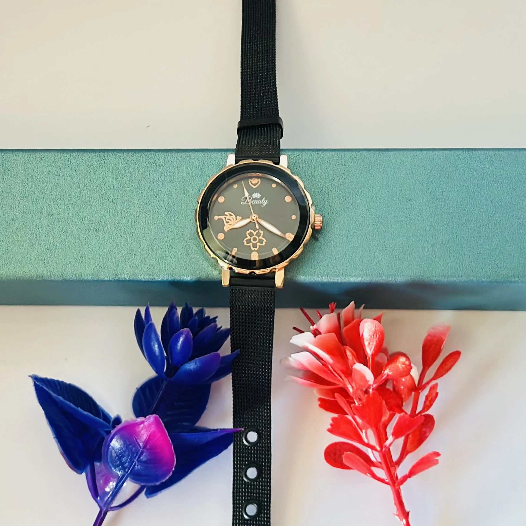 analog watch with a black magnetic strap
