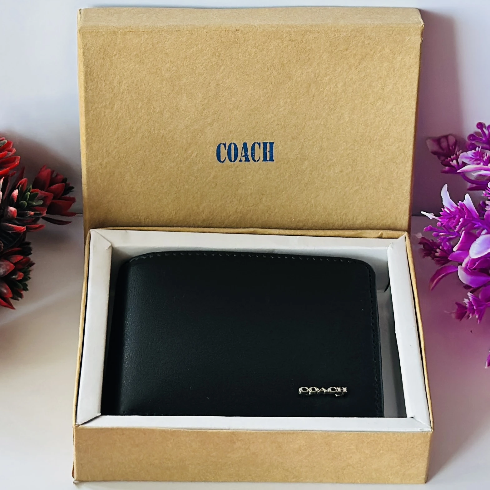 Black genuine leather bifold wallet from Coach.