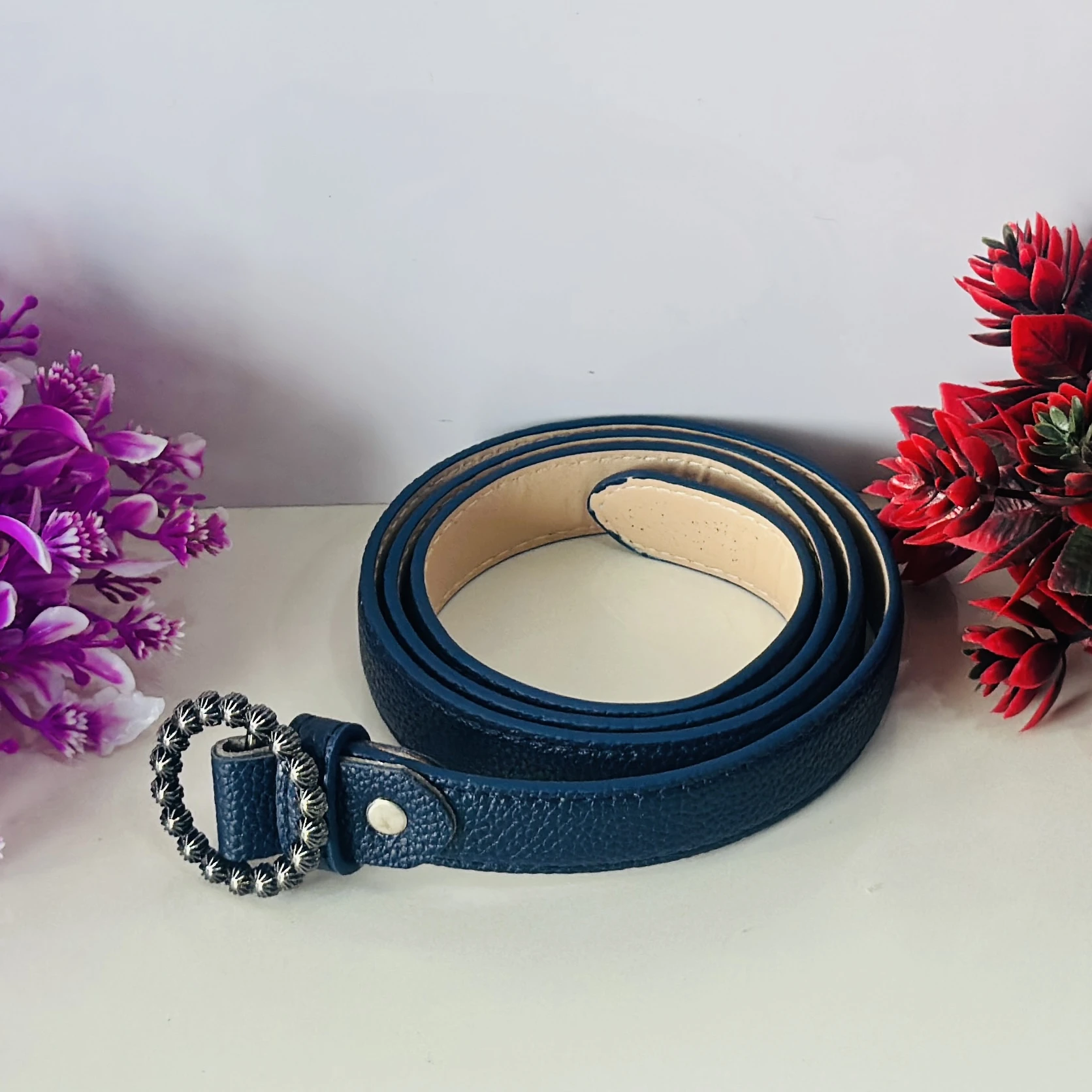 Blue Togo leather belt strap with a decorative buckle.