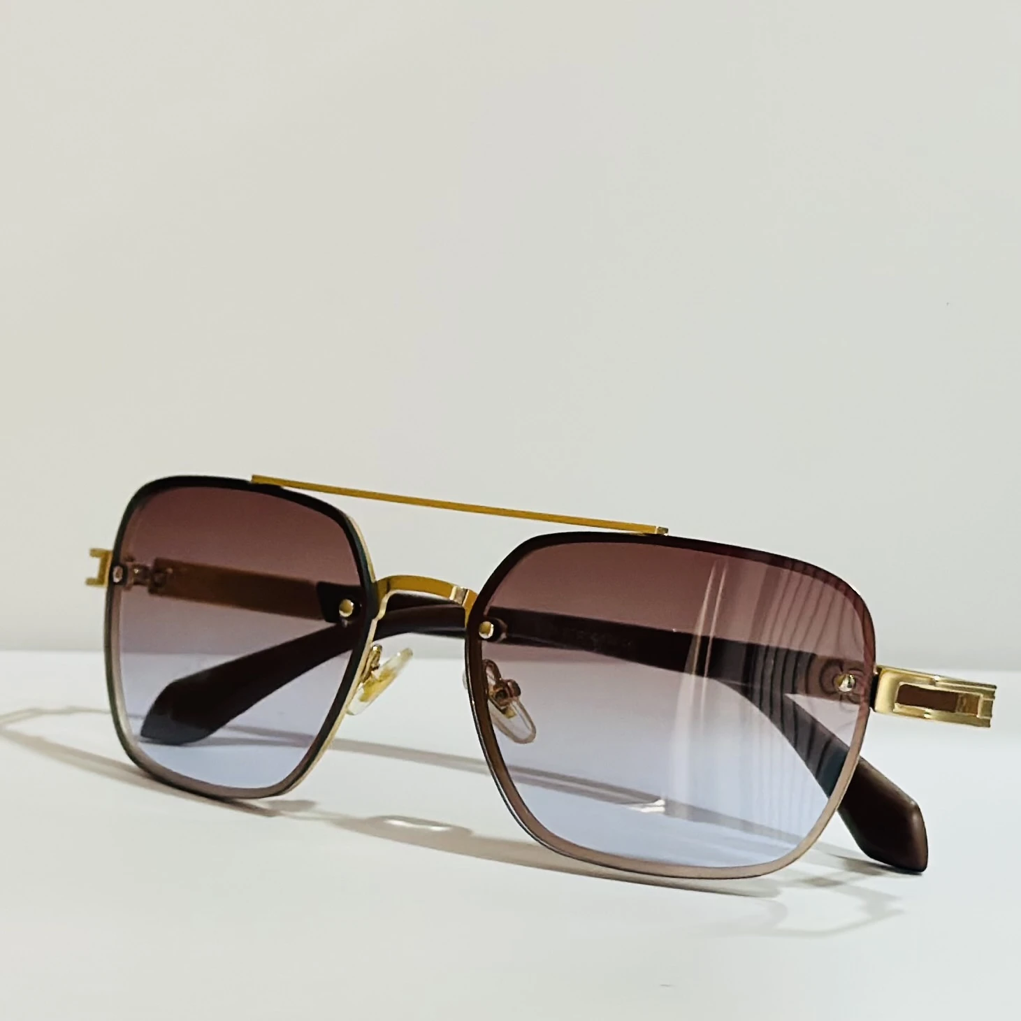 pair of Maybach square gradient sunglasses with a gold-tone frame.