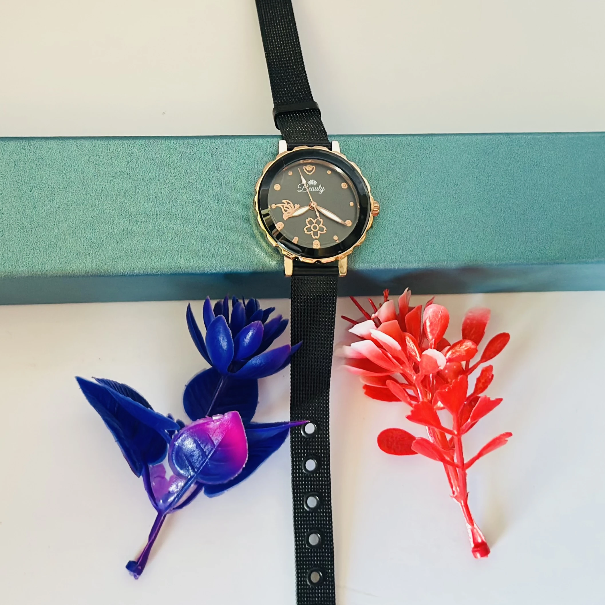analog watch with a black magnetic strap