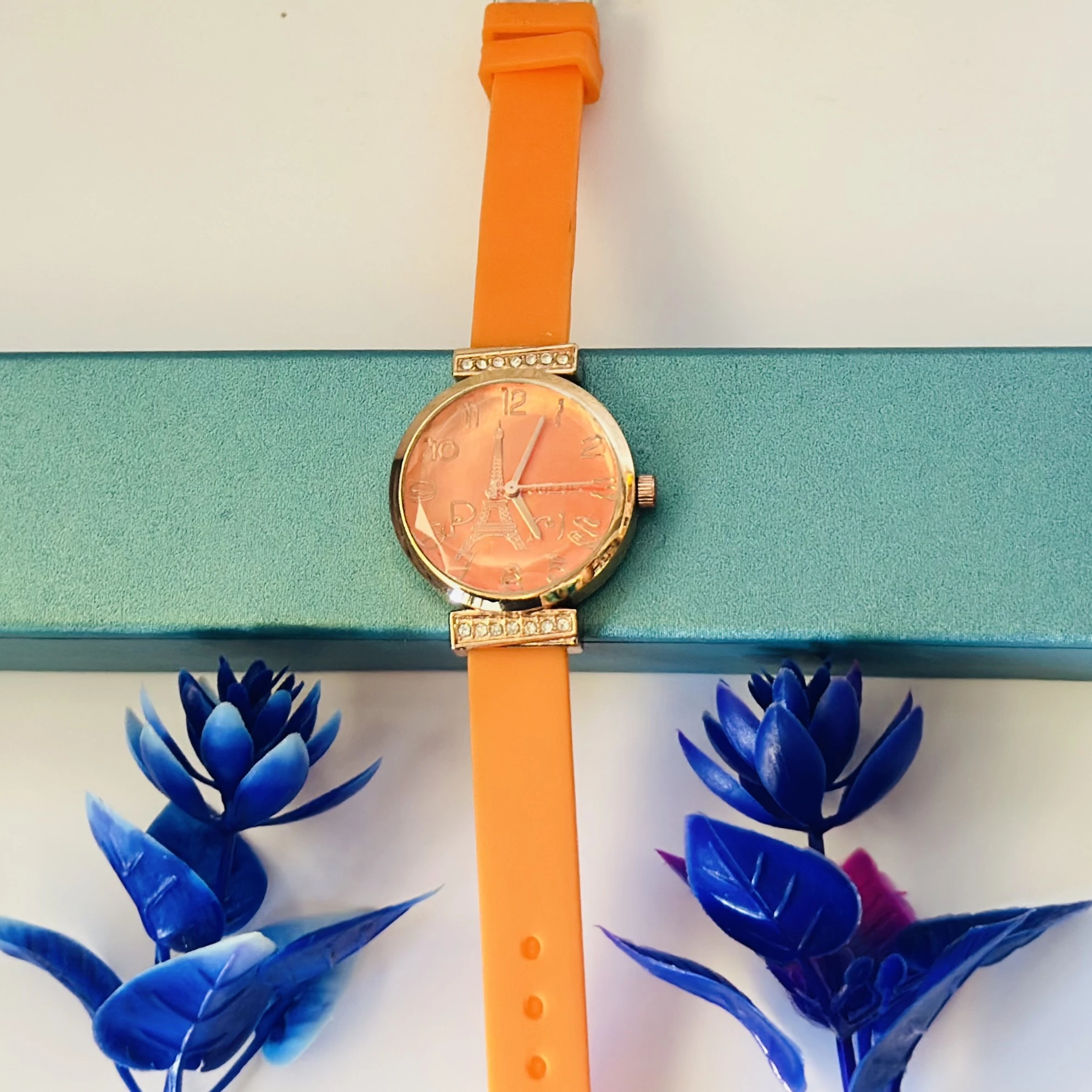 Women's Metal Analog Watch with an orange silicone strap