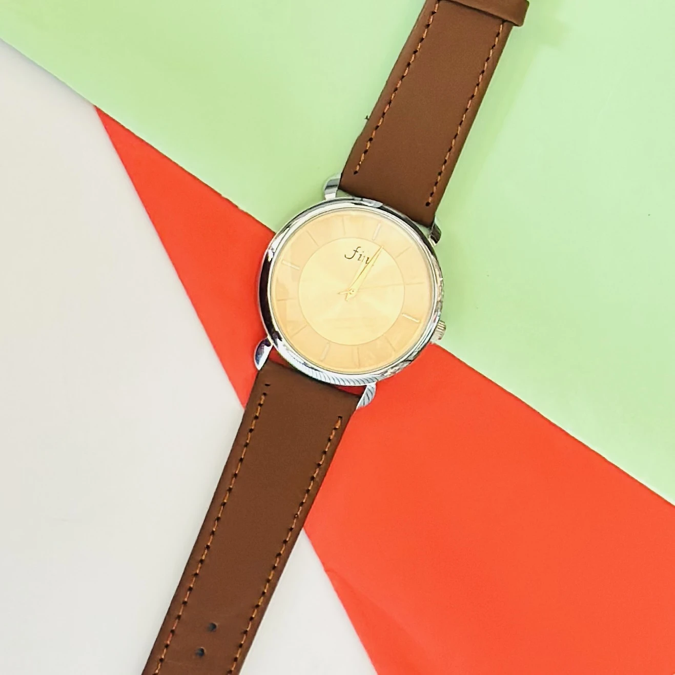 Analog wristwatch with a gold-tone case and a brown leather strap.