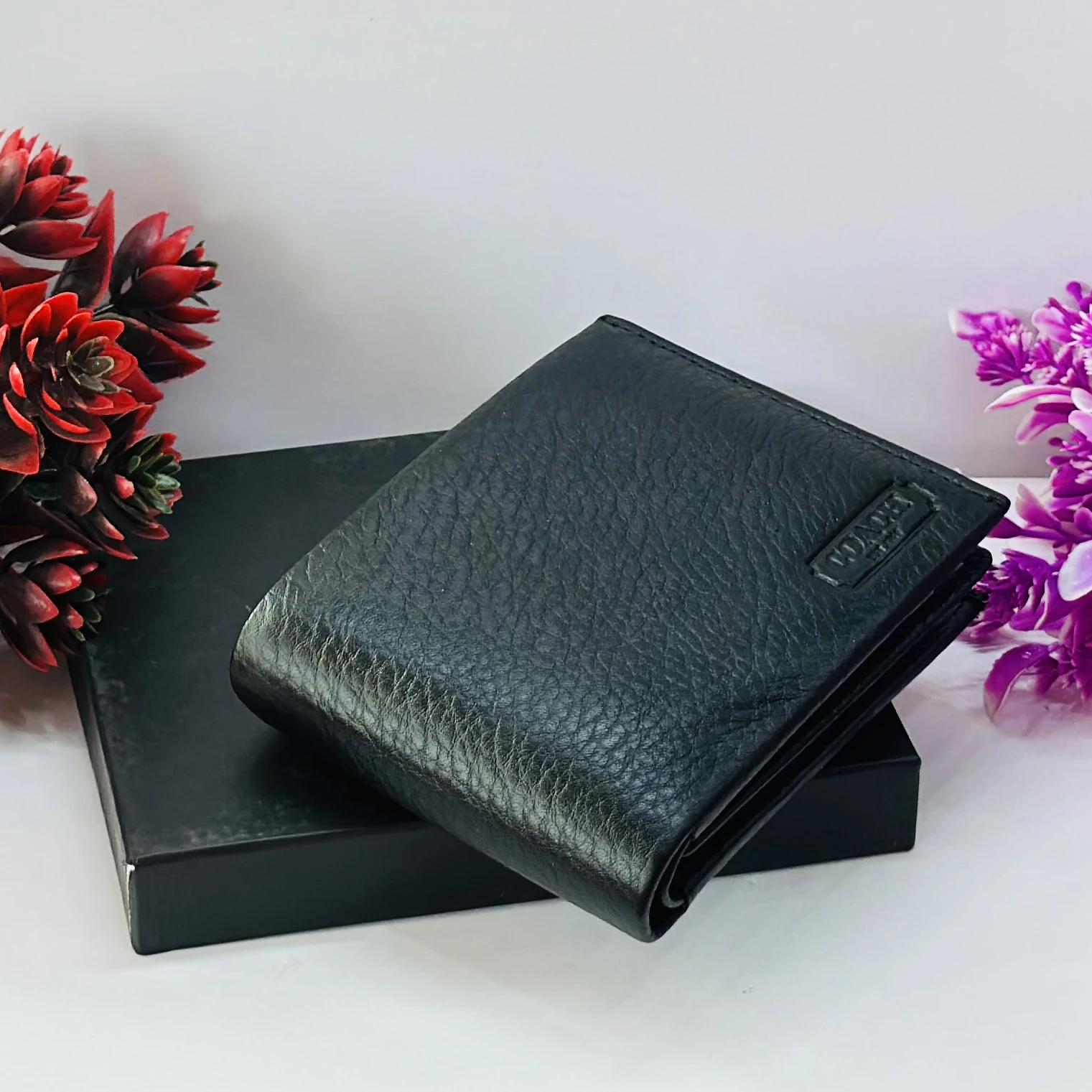 Coach men's black leather slim bifold wallet.