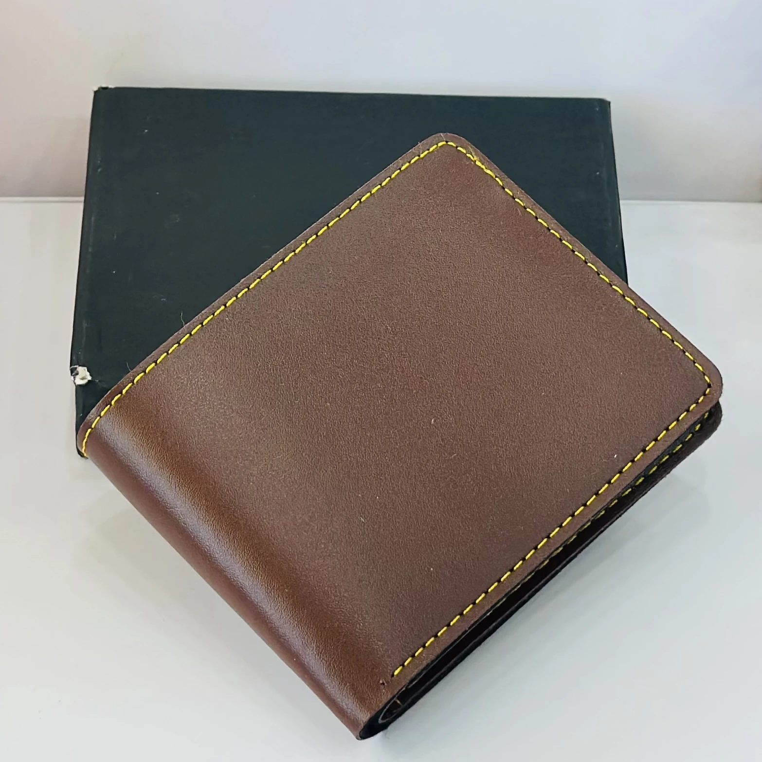 Crusset men's brown bi-fold wallet made of PU material.