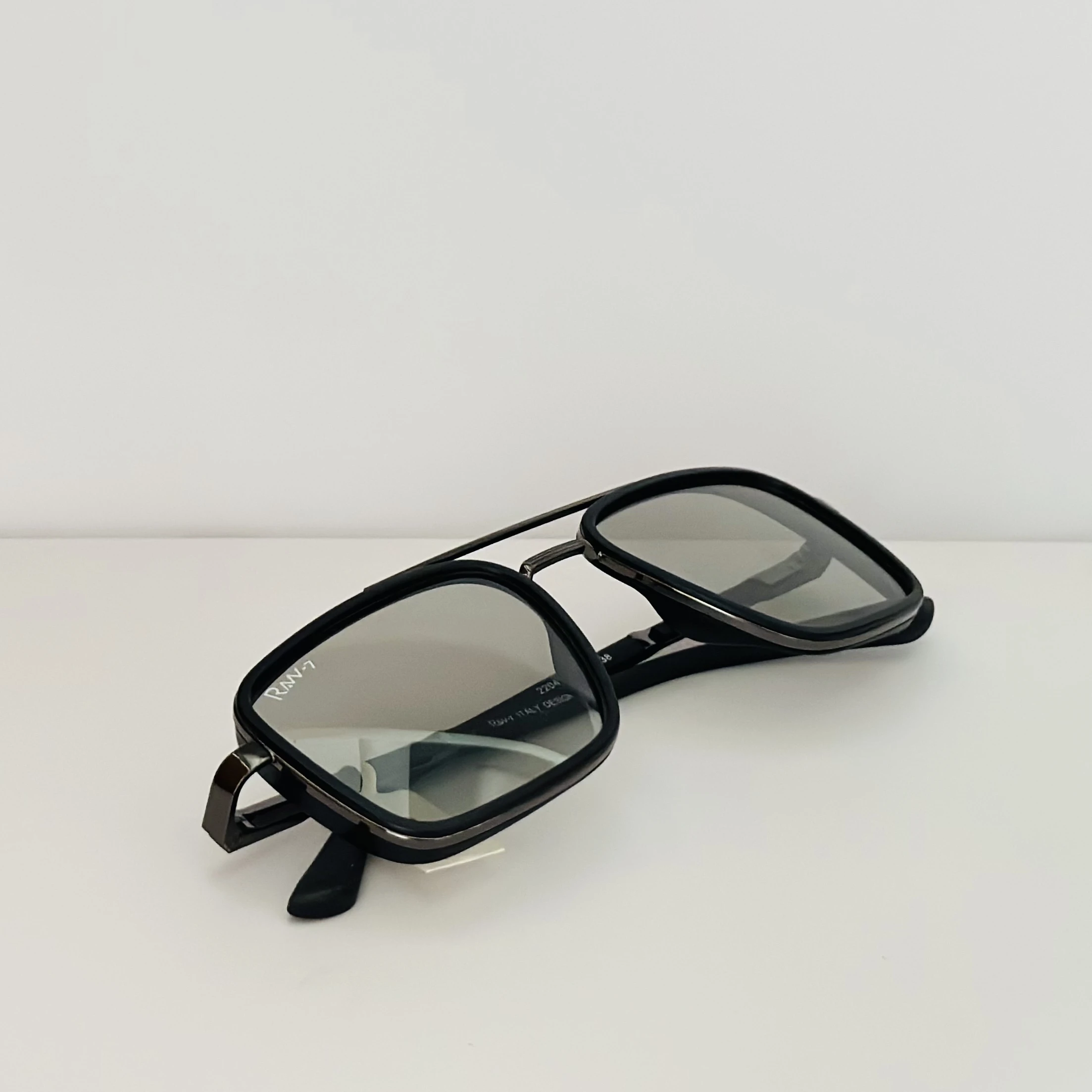 RAW-7 aviator sunglasses with a black frame and silver lenses.