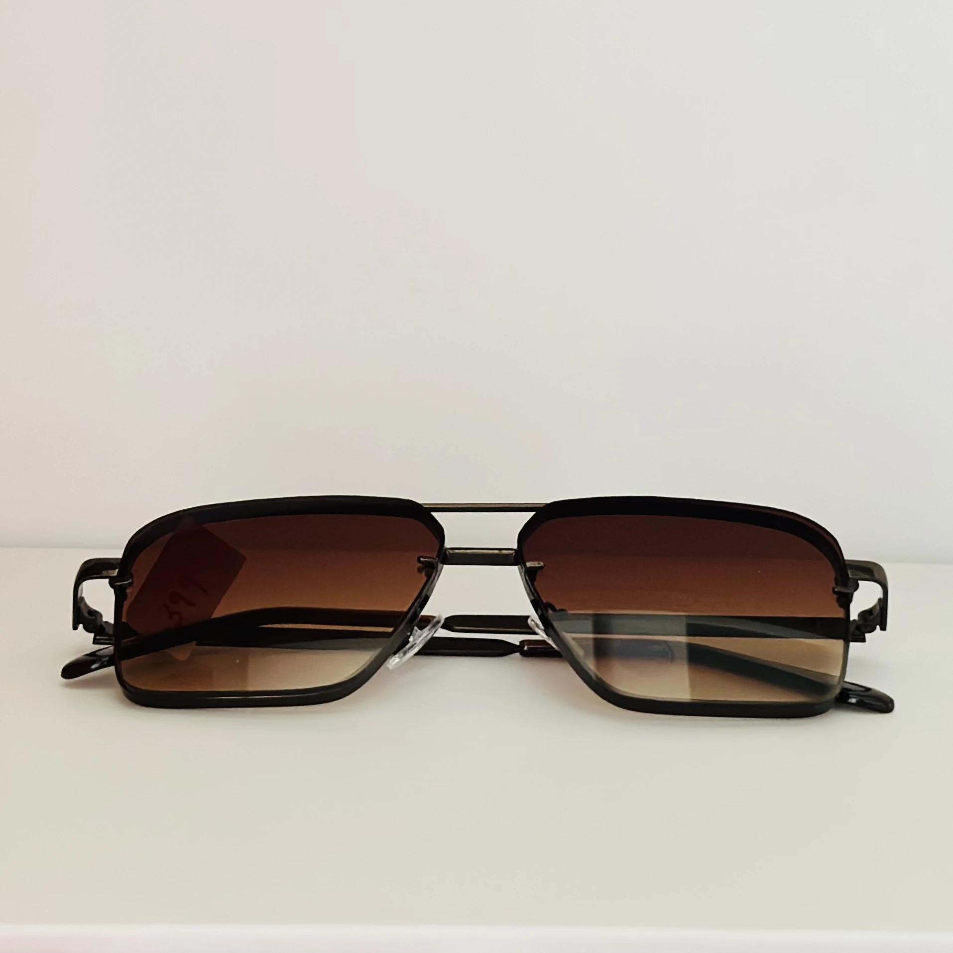 pair of square aviator gradient sunglasses with a brown metal frame.