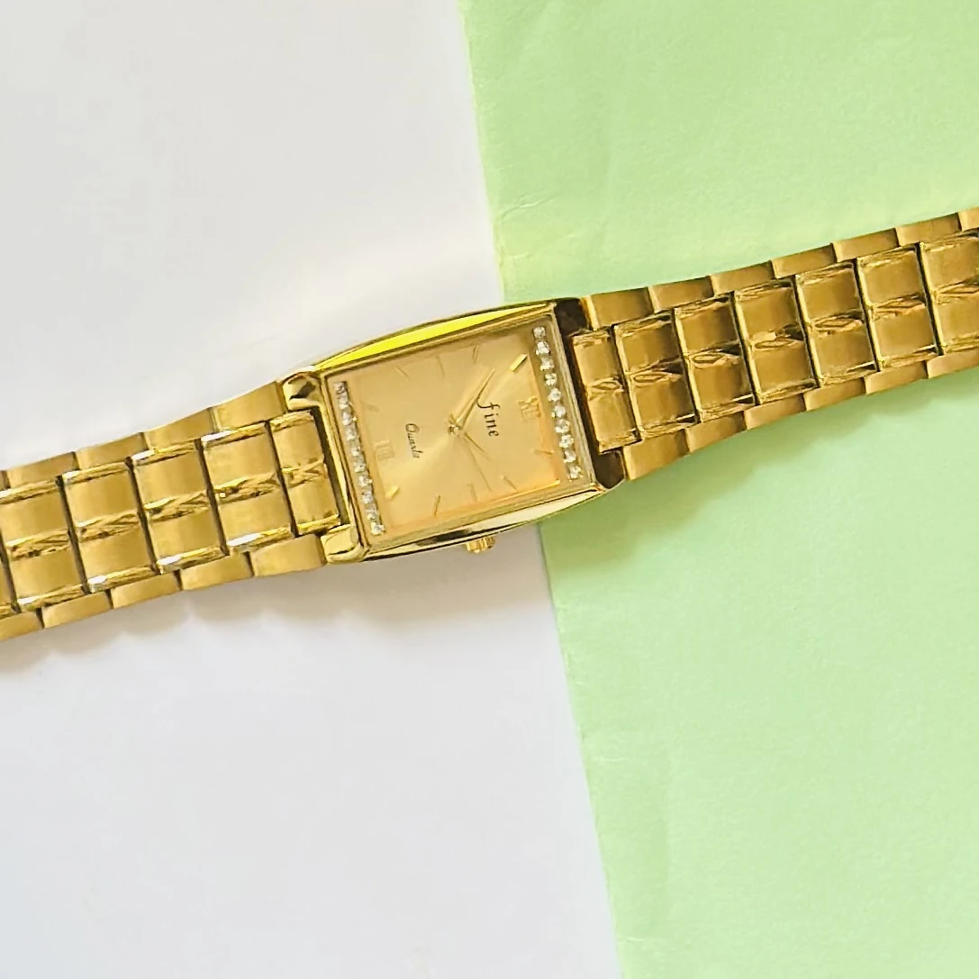 Gold plated stainless steel analog quartz watch.