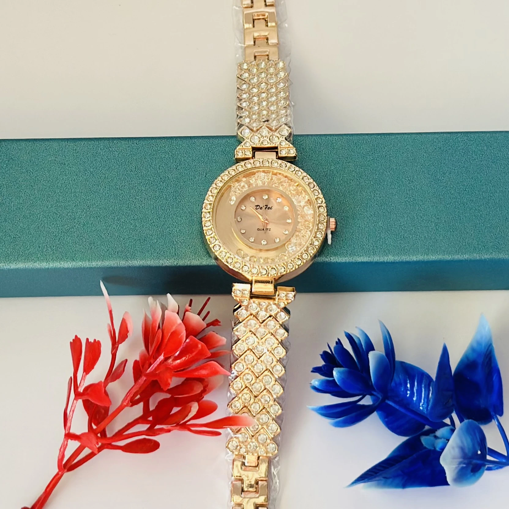 Ladies crystal watch with a rose gold-tone band and crystal-studded dial.