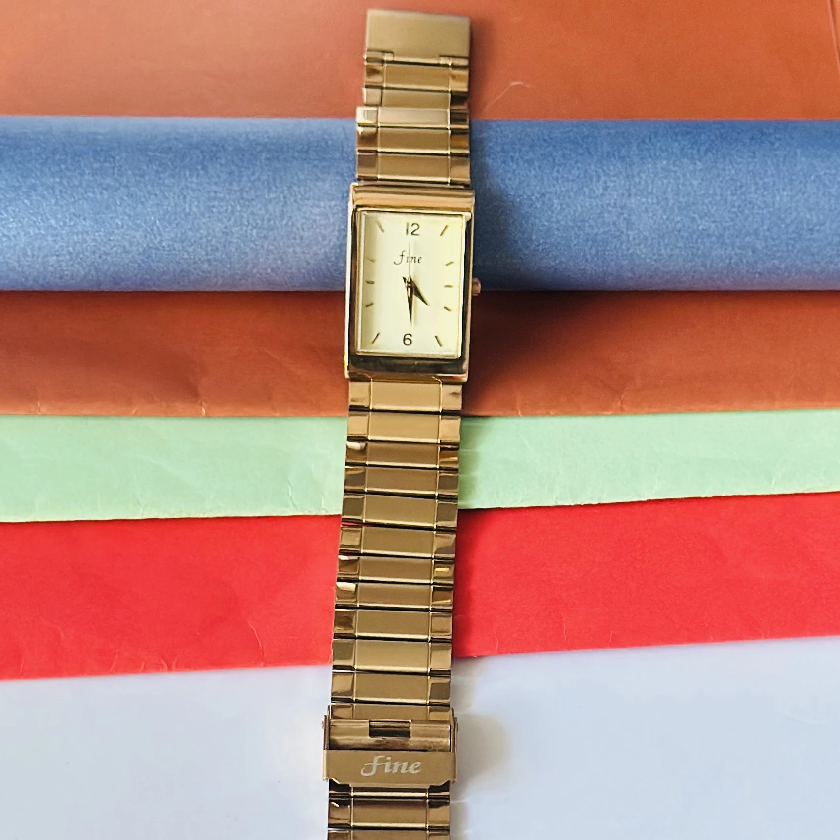 Gold -tone analog quartz watch with a metal strap.