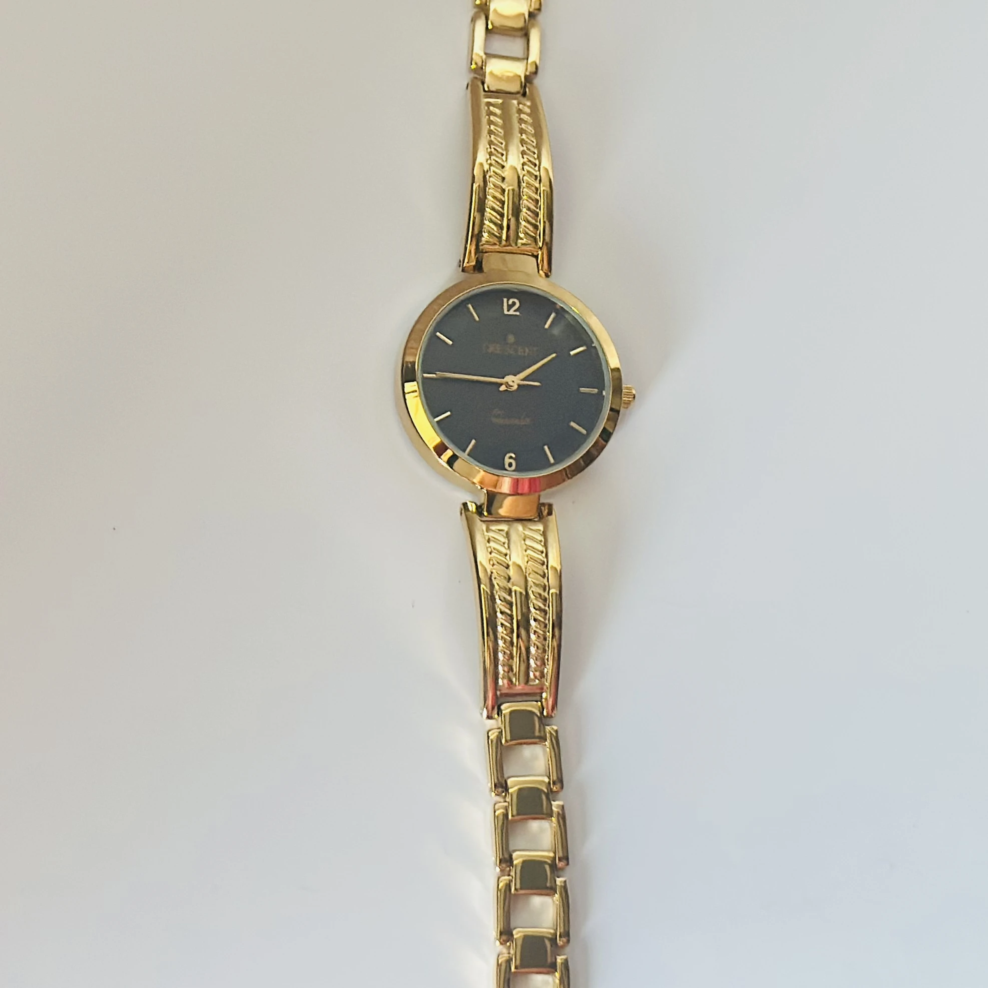 Anne Klein black dial gold-tone and black resin ladies watch.