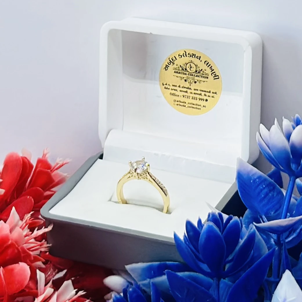 Yellow gold engagement ring with a central stone and side accents.