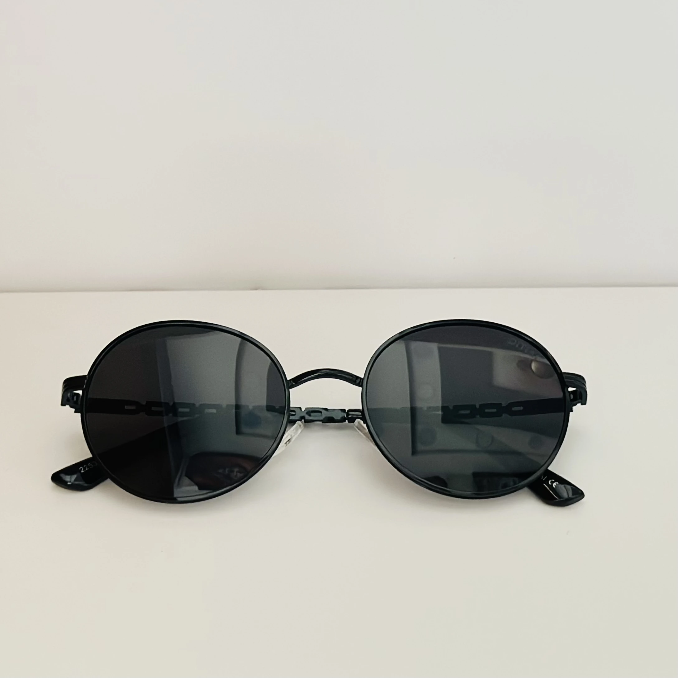 Moncler Tatou ML 0224 sunglasses in black metal with round lenses.