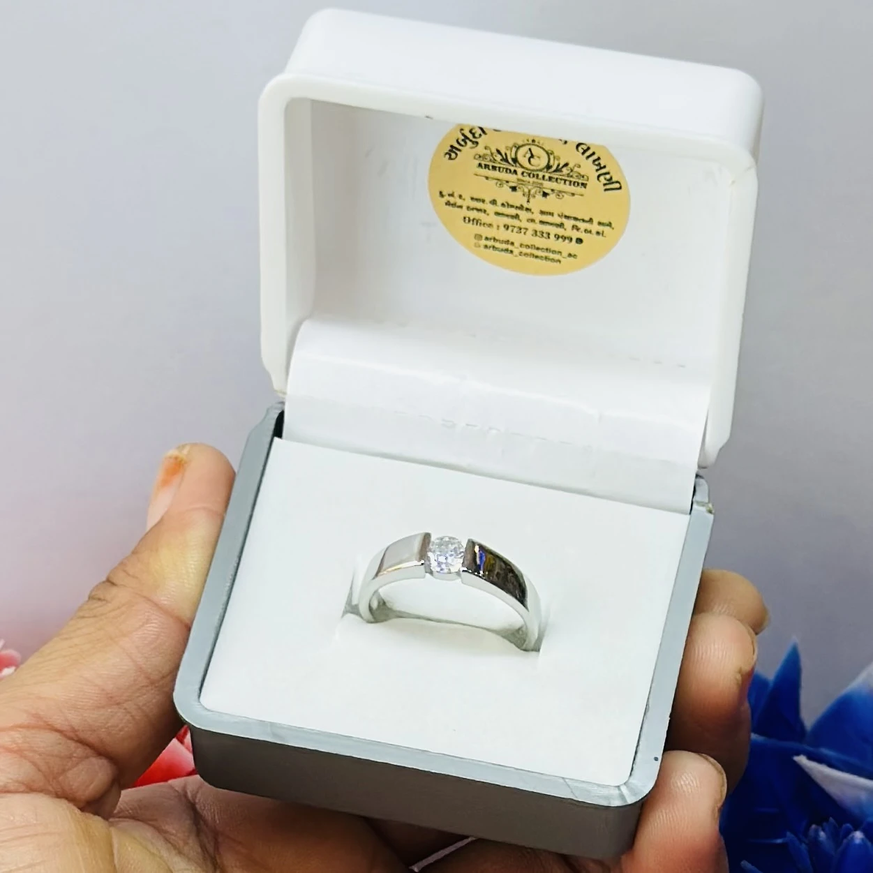 silver solitaire ring with a modern tension-style