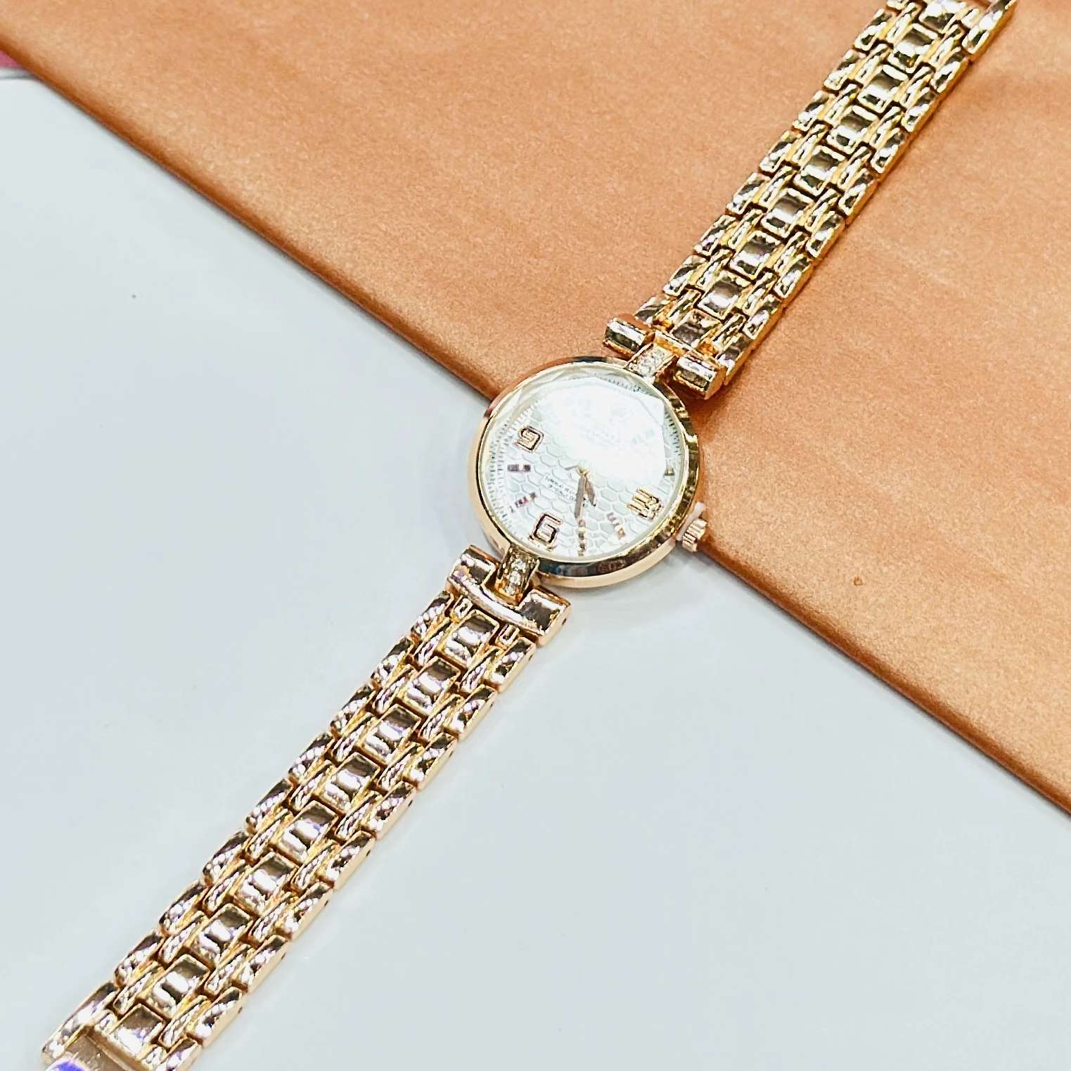 gold-tone ladies' watches with a sparkling bezel and metallic strap