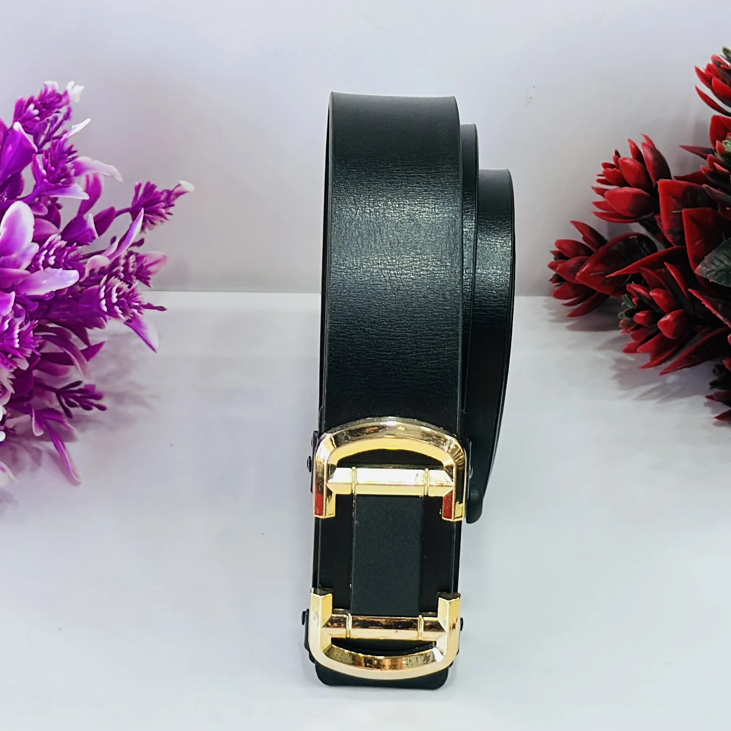 Black leather belt with a gold-tone buckle.