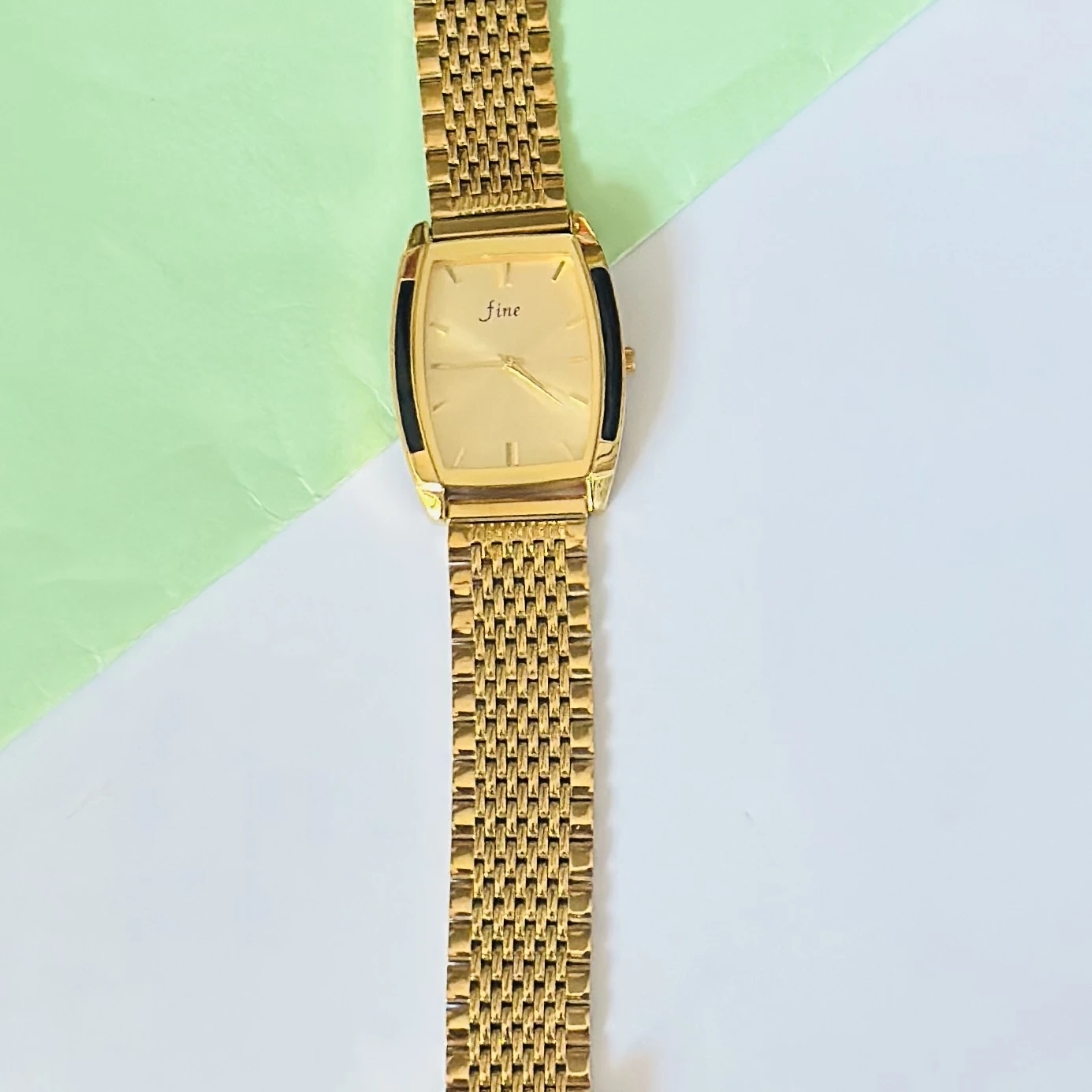Gold -tone analog quartz watch with a metal strap.