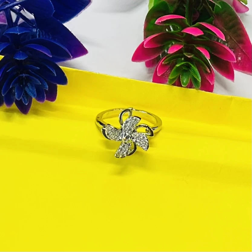 silver floral-shaped ring adorned with sparkling cubic zirconia or diamonds.