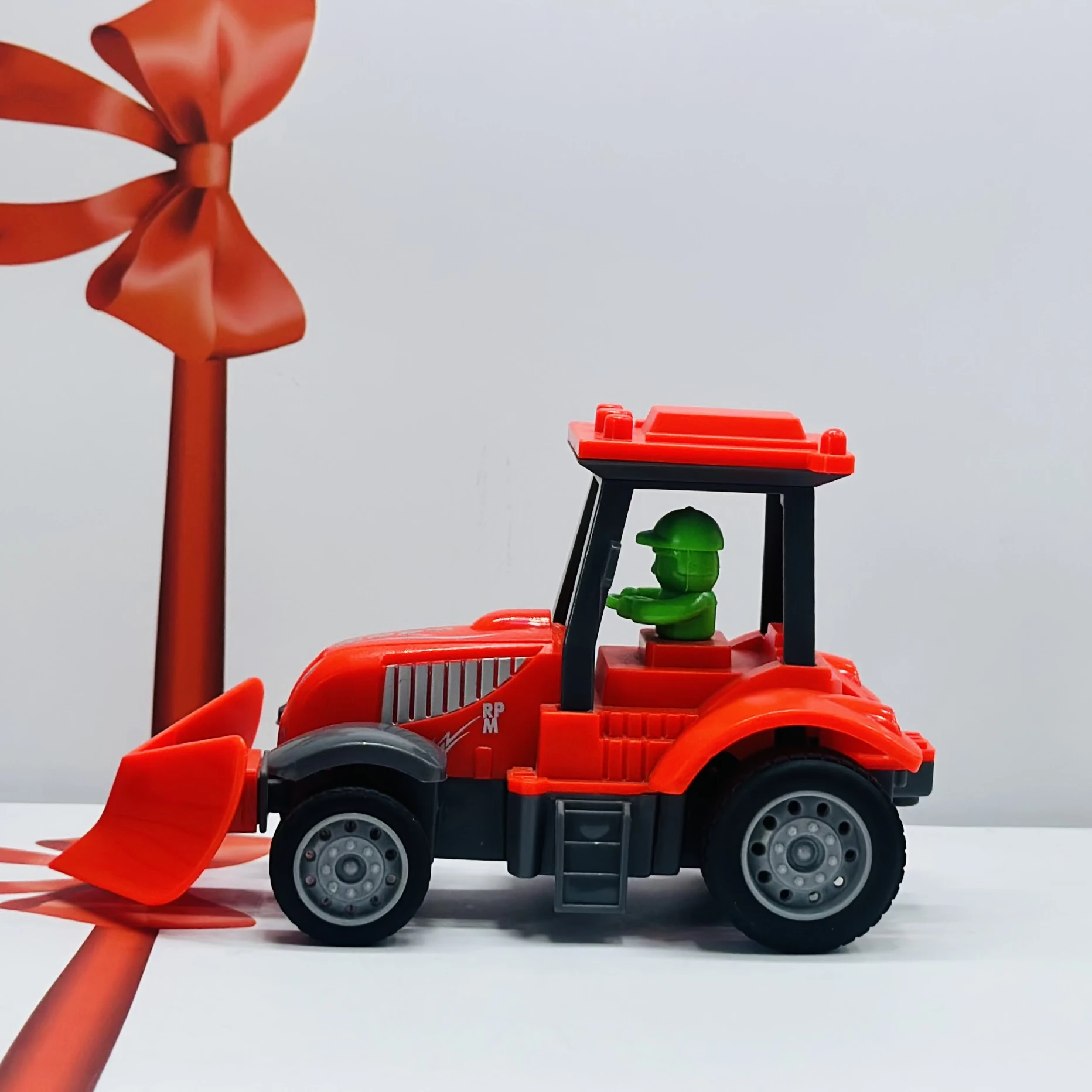 Red plastic toy tractor