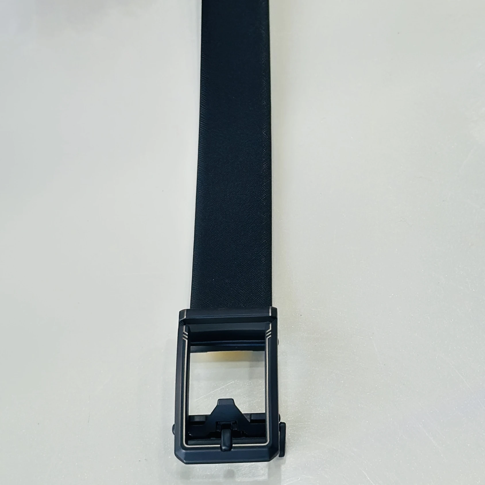 Black Saffiano leather reversible belt with a gunmetal buckle.