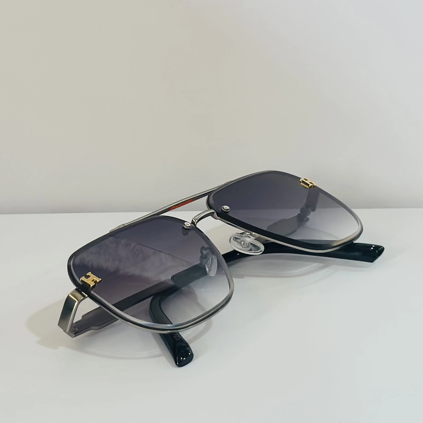 pair of Maybach aviator sunglasses with black and gold details.
