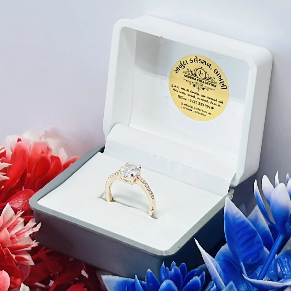 Gold toned ring with a large central clear stone