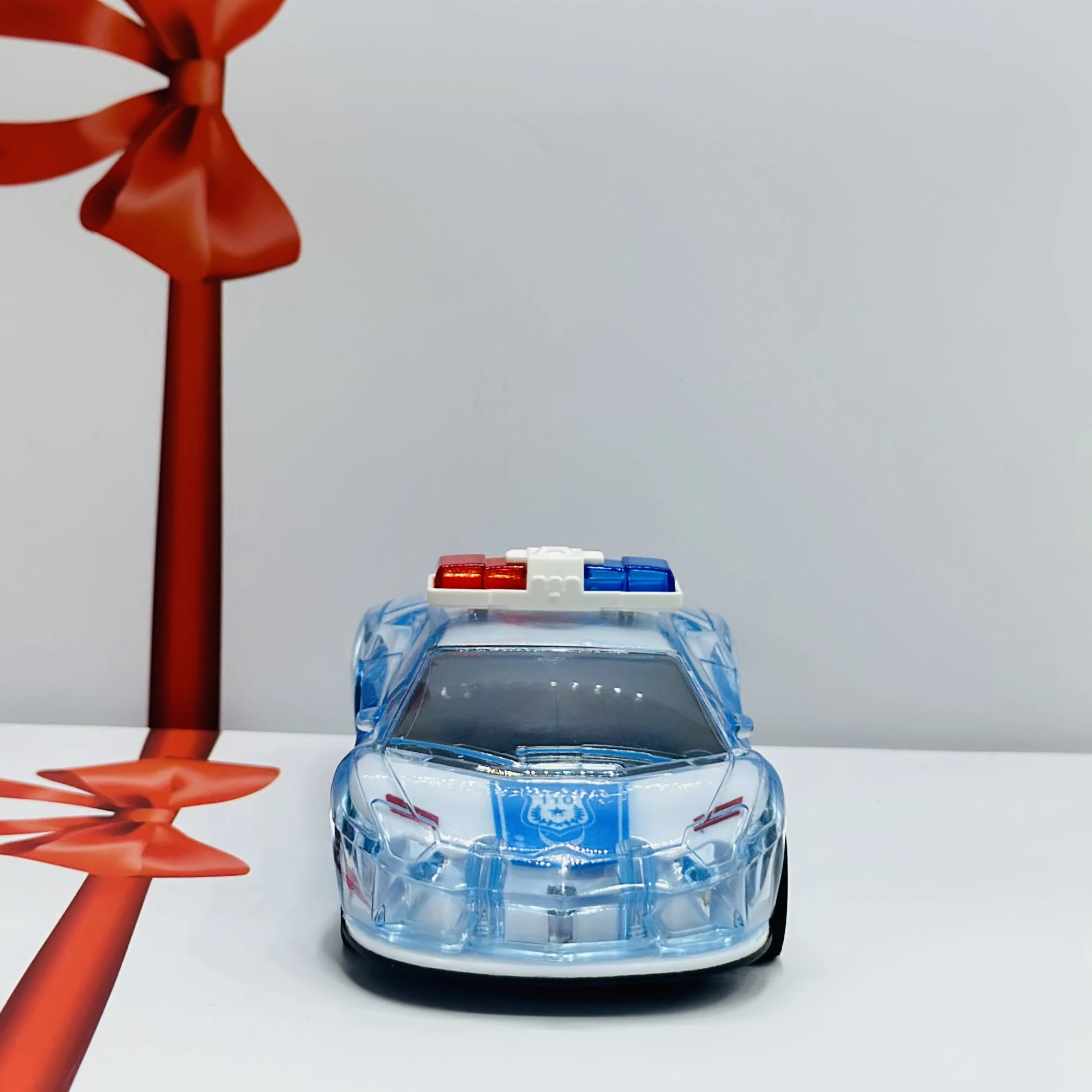 Toy police car with a transparent body and light-up features.