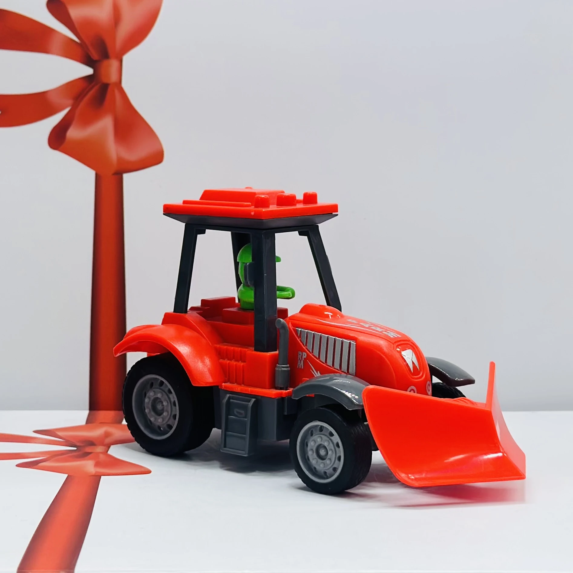 Red plastic toy tractor