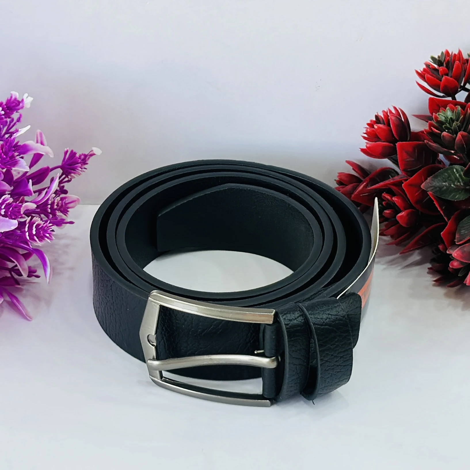 Black leather belt with a metal buckle.