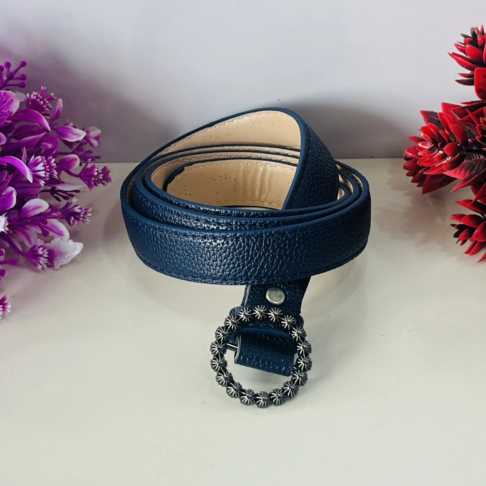Blue Togo leather belt strap with a decorative buckle.
