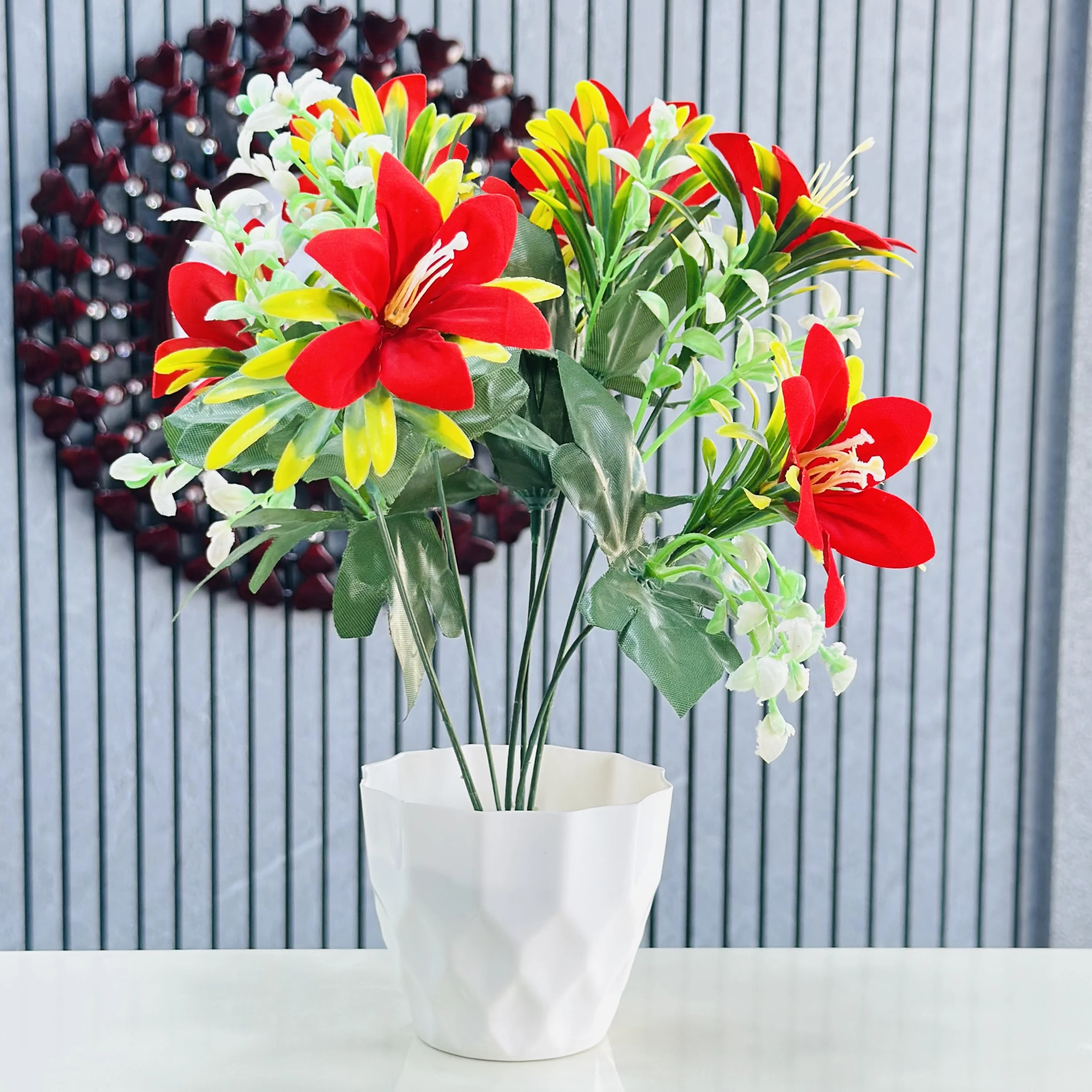 lily flower arrangement in a white pot.
